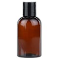 4 oz. Clarified Amber PET Cosmo Round Bottle with 20/410 Black Polypropylene Disc-Top Dispensing Cap