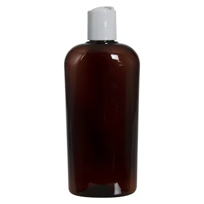 15.2 oz. Light Amber PET Vale Oval Bottle with 28/410 White Polypropylene Disc-Top Dispensing Cap with 0.330" Orifice