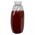 18 oz. Clear PET Inverted Oval Sauce Bottle with 38/400 White Ribbed Snap-Top Dispensing Cap with Pressure-Sensitive Liner