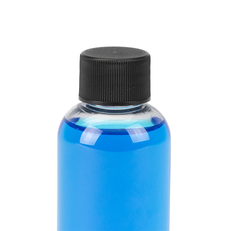 2 oz. Clear PET Traditional Boston Round Bottle with 20/410 Black Ribbed Cap with F217 Liner