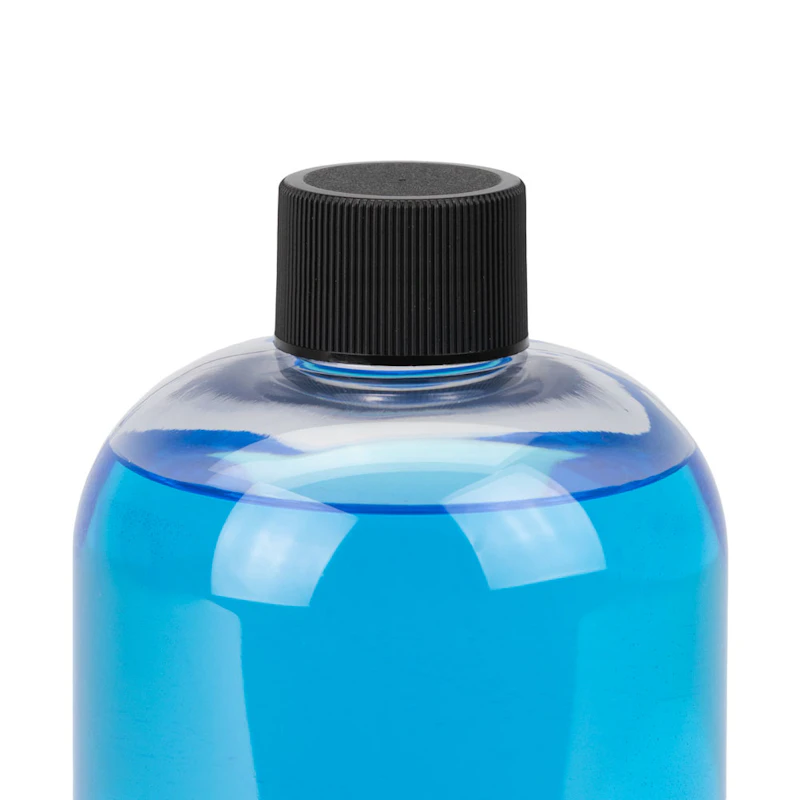 16 oz. Clear PET Traditional Boston Round Bottle with 24/410 Black Ribbed Cap with F217 Liner