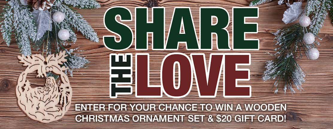 A wooden ornament and wreath on a wood background. Text reads, 'Share the Love: Enter for your chance to win a wooden Christmas ornament set & $20 gift card!'