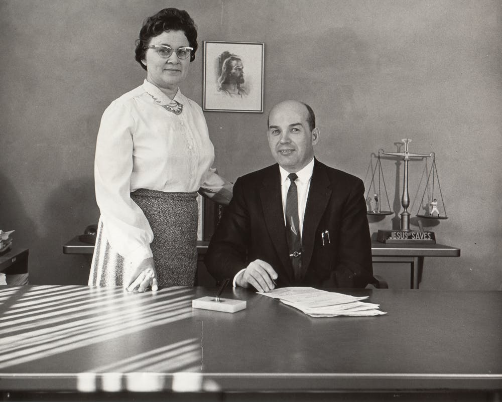Stanley and his wife, Juanita, behind a desk