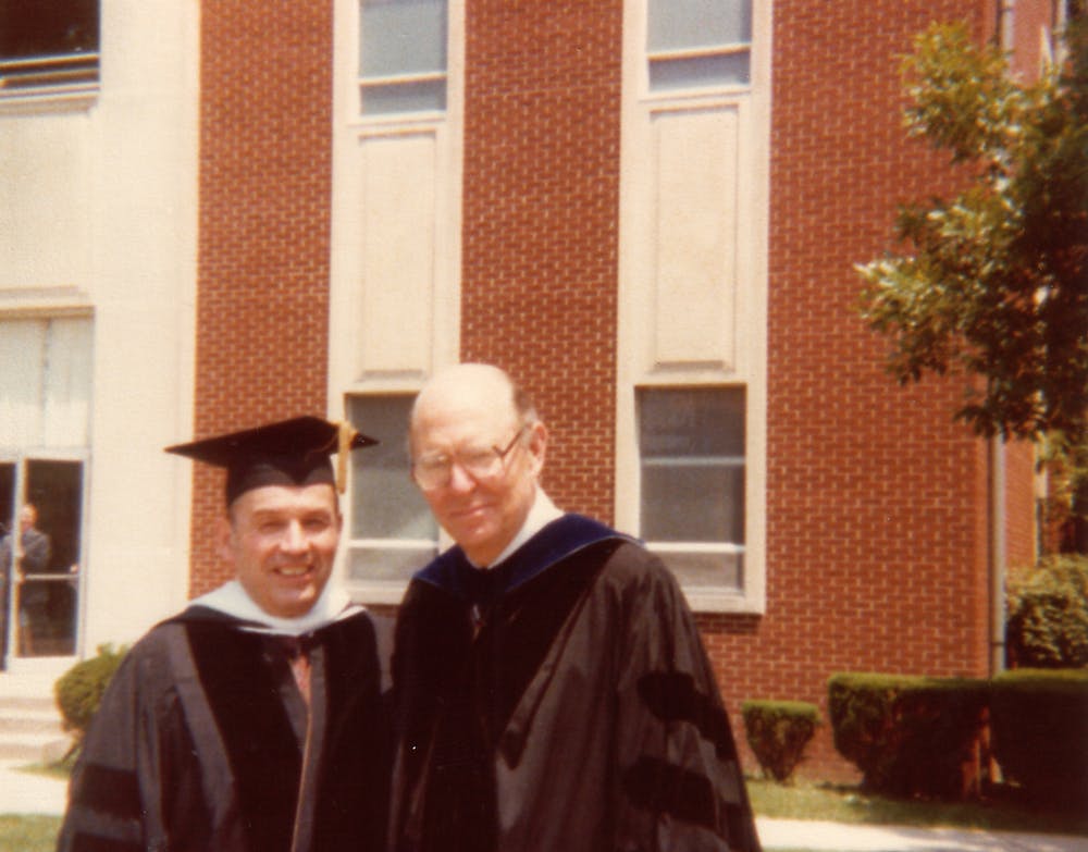 Stanley and Dr. Kinlaw wearing academic gowns at Asbury College