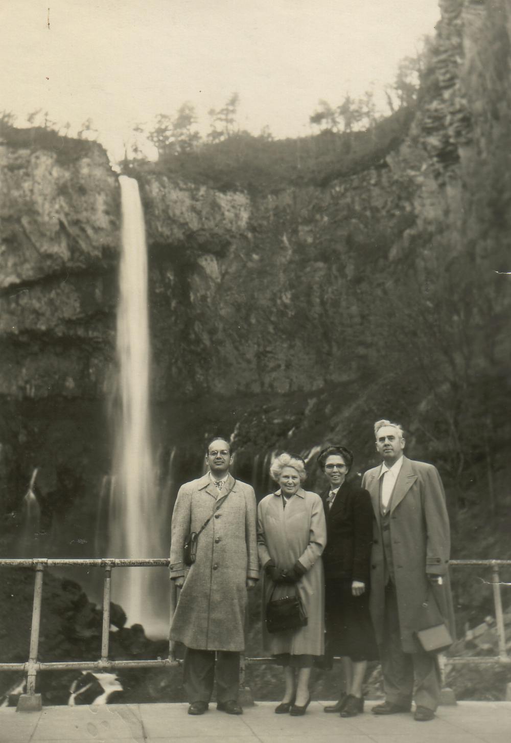 Stanley and three others standing in front of a waterfall