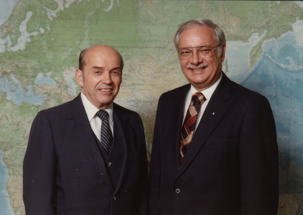 Stanley and Charlie Spicer in front of a large wall map