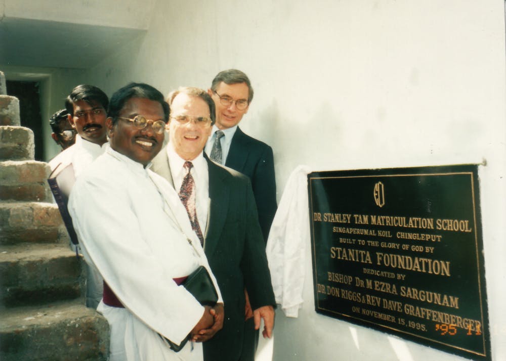 Five men by a dedication plaque for a new seminary funded by the Stanita foundation
