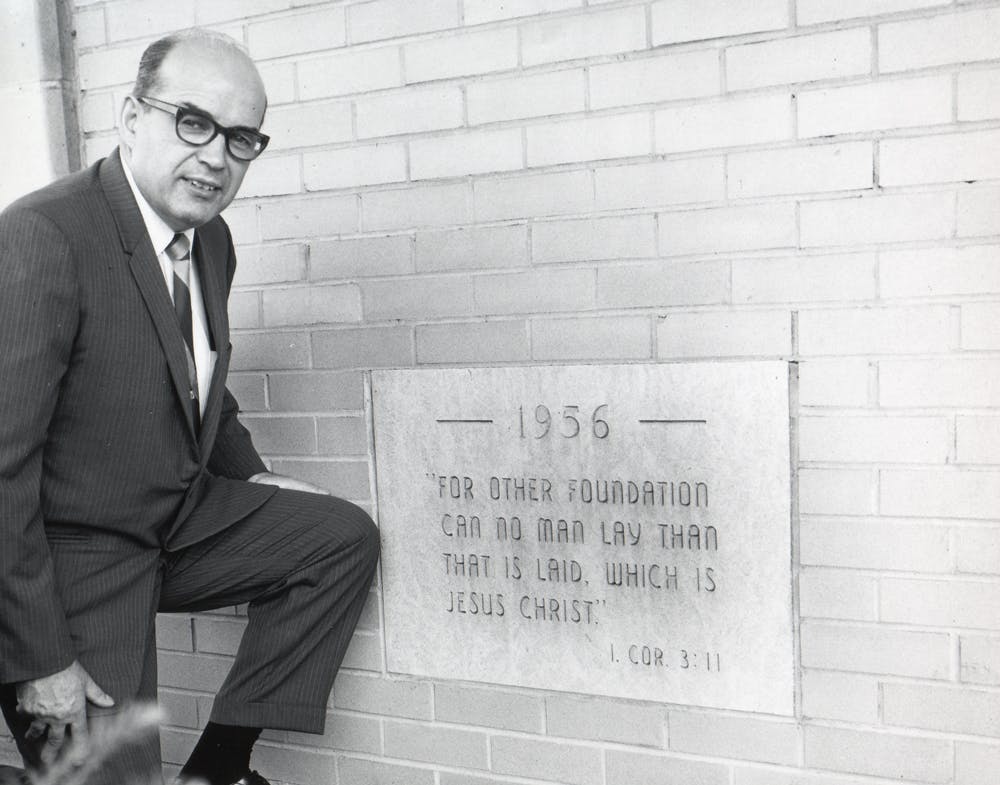 Stanley with a dedication plaque outside his new building