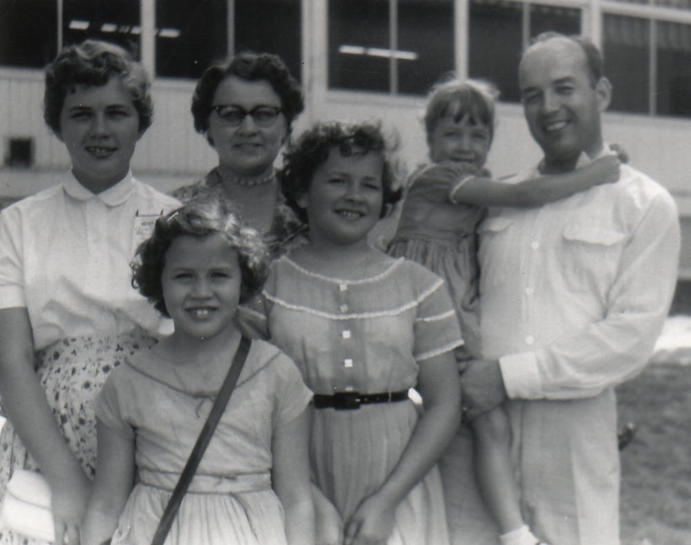 Stanley with his wife and four children outside a building