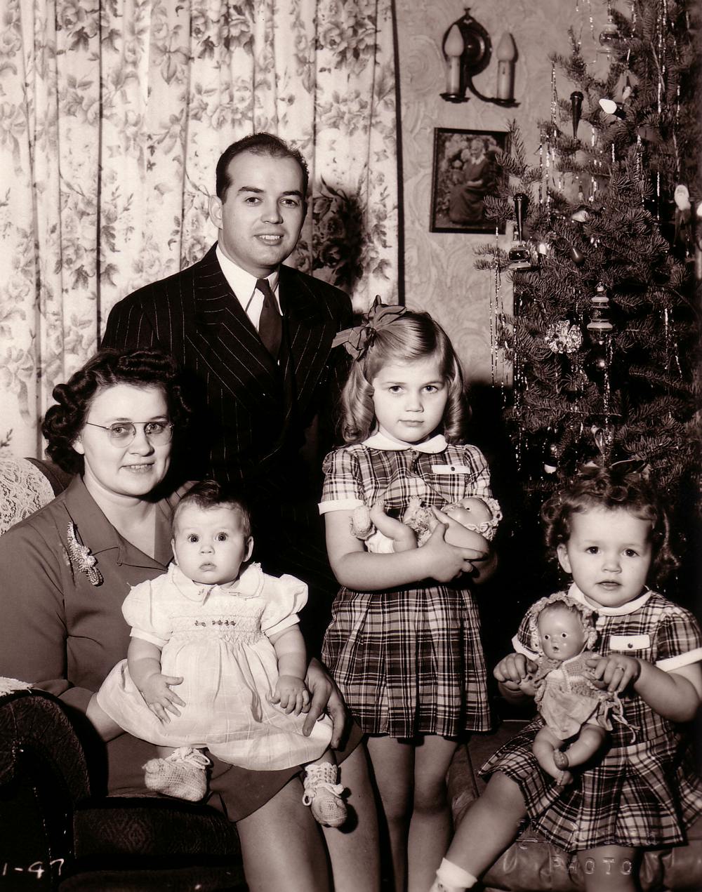 Stanley with his wife and three children next to a Christmas tree
